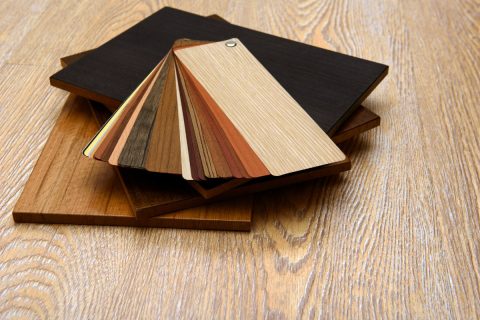 A selection of wood samples on a table for choosing hardwood floors.