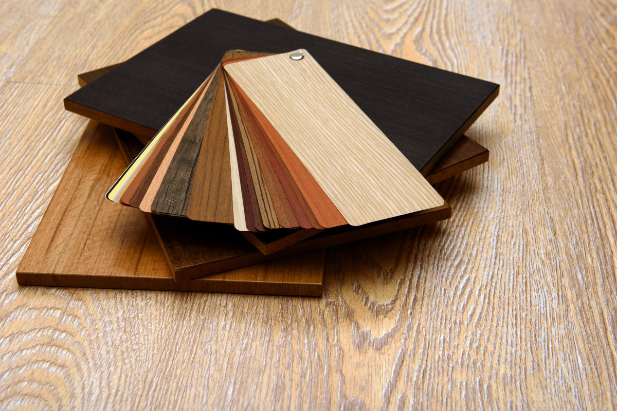 A selection of wood samples on a table for choosing hardwood floors.