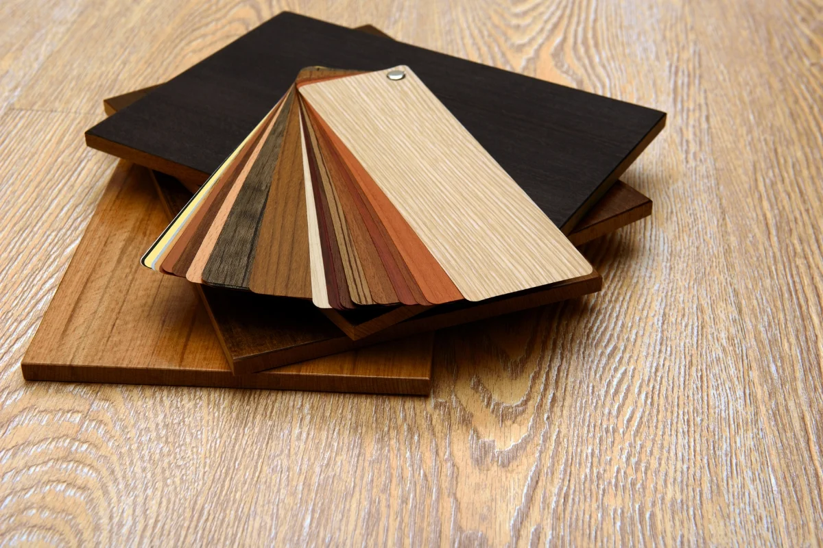 A selection of wood samples on a table for choosing hardwood floors.
