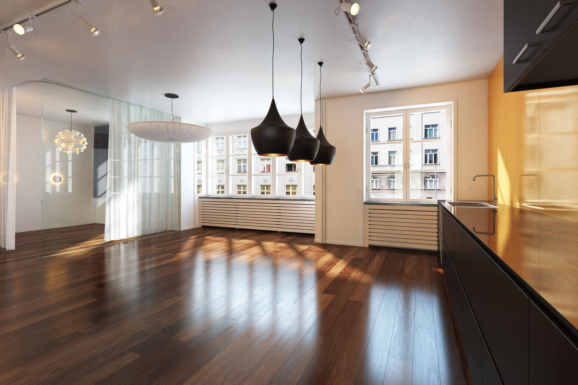 An empty kitchen with hardwood floors.