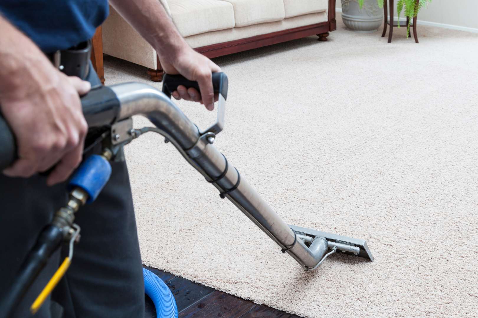 Carpet Flooring 7 A man vacuuming carpet flooring.
