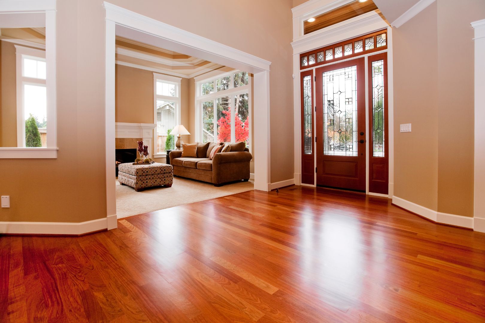 An empty living room with hardwood floors.