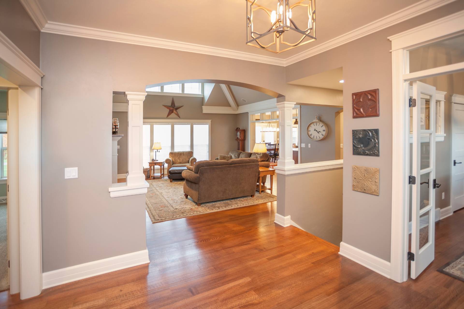 Hardwood Flooring Installation 2 A living room with hardwood floors and an archway.