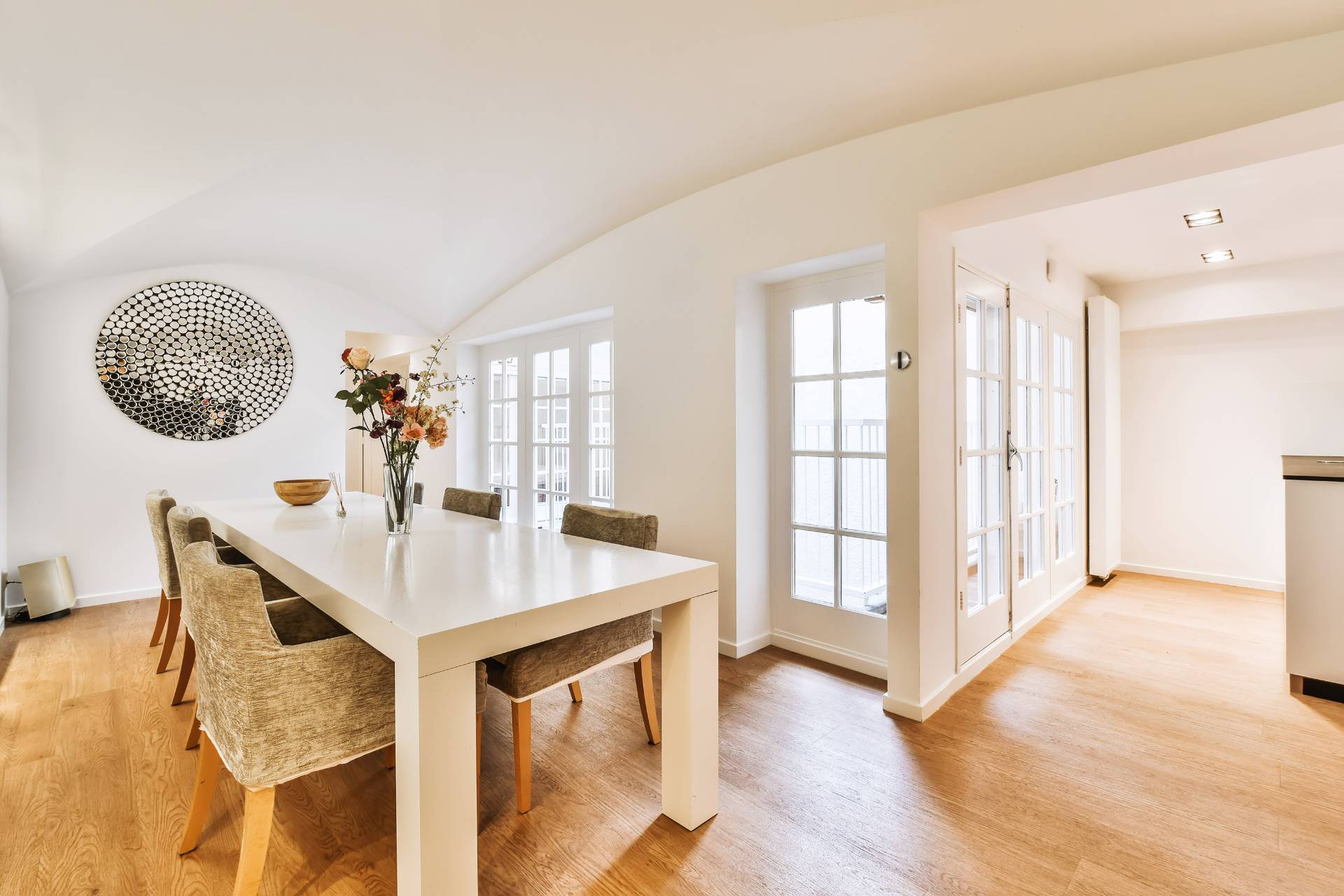 Vinyl Flooring 1 A dining room with a white table and chairs on laminate flooring.
