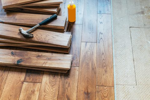 Hardwood Flooring 10 A hardwood floor is being installed using a hammer.