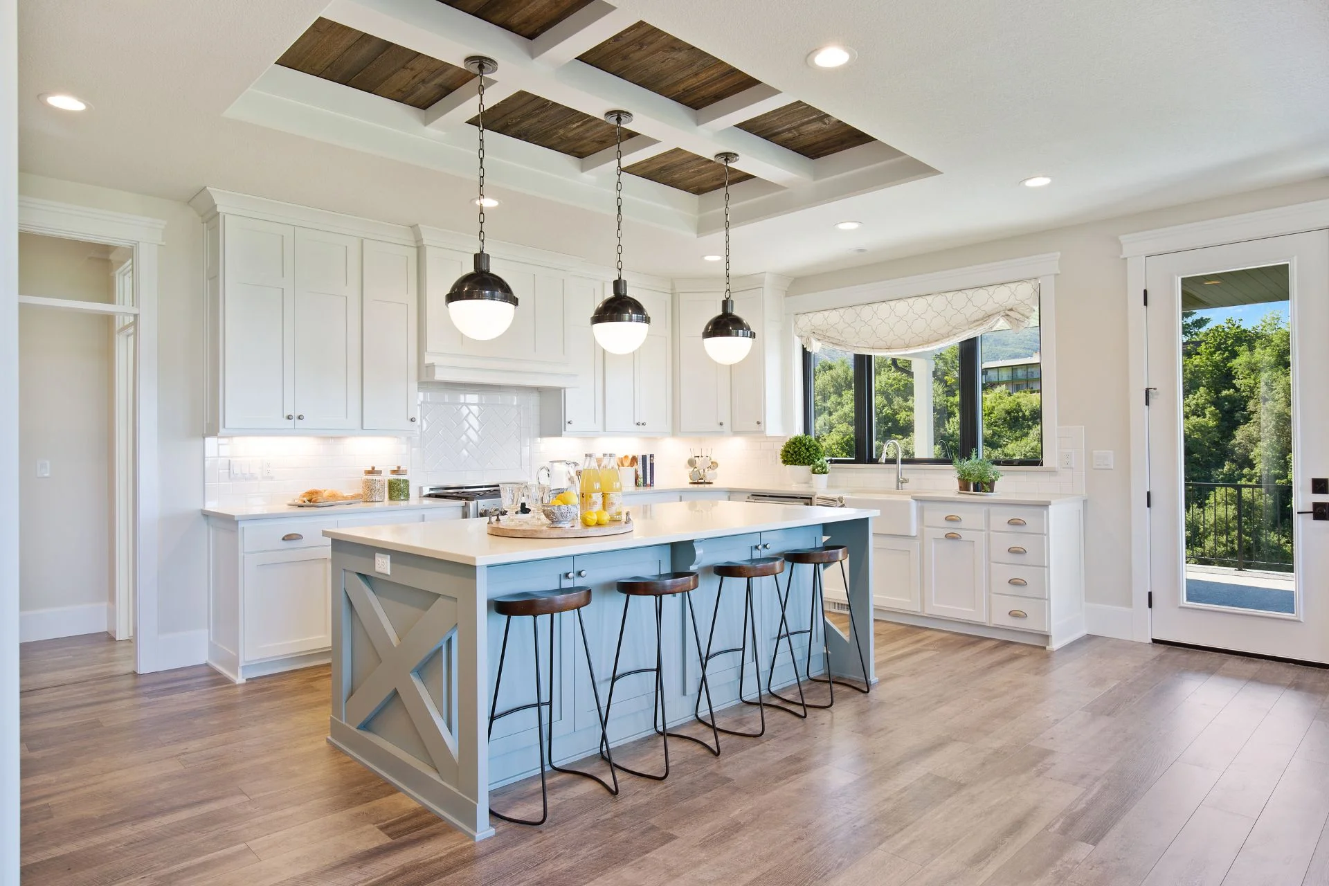 A white kitchen with vinyl flooring and a center island.