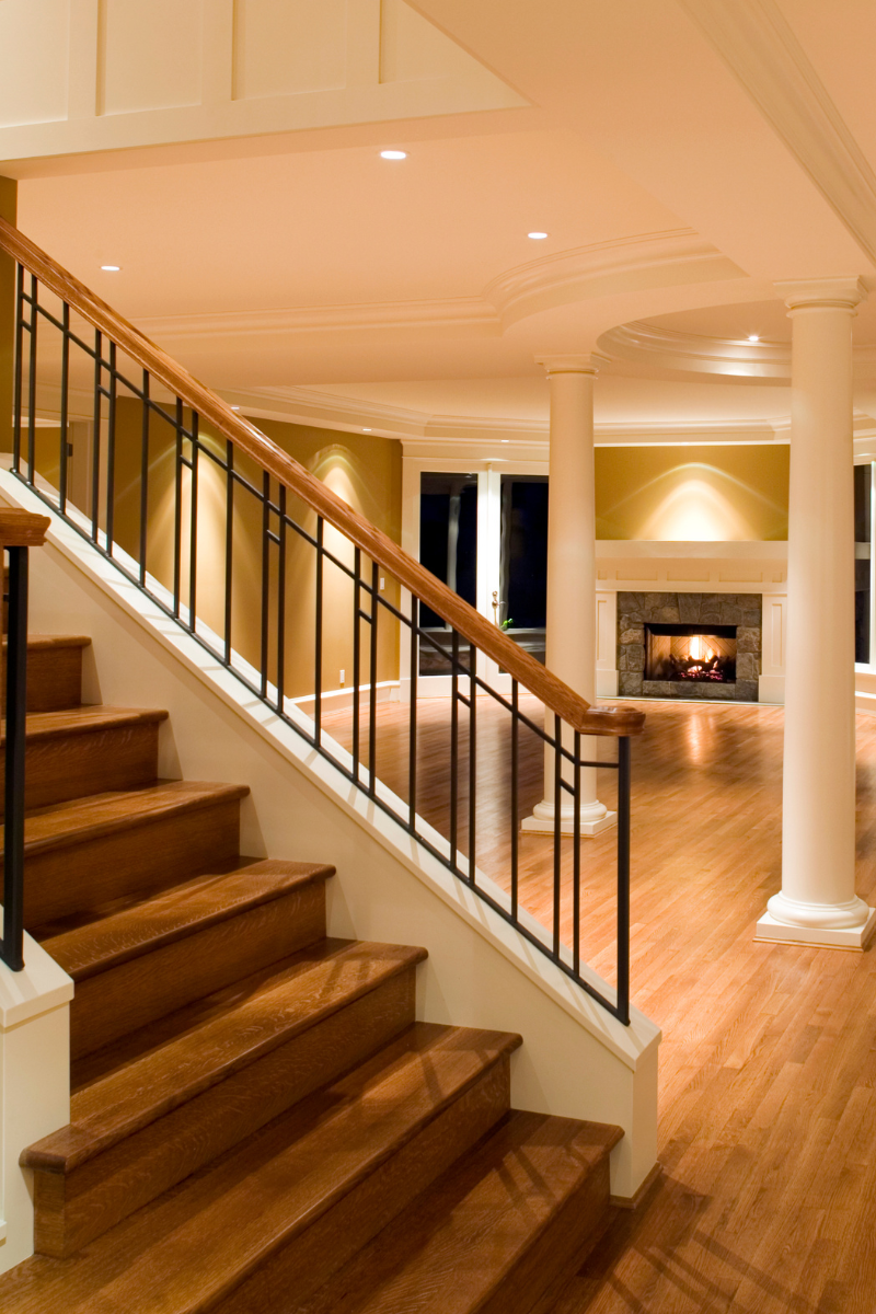 Acworth Flooring Company 9 A staircase leading to a living room with a fireplace renovated by Acworth Flooring Company.