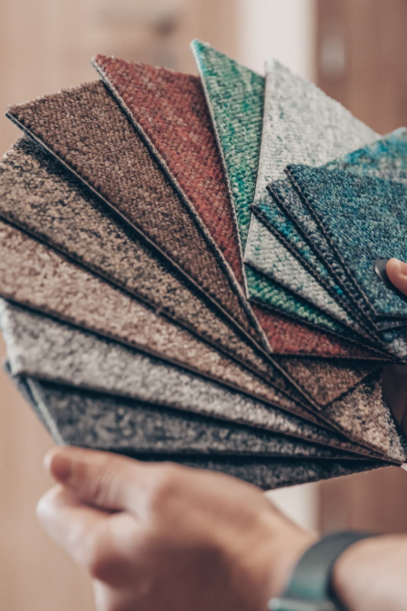 An Atlanta Flooring Company representative showcasing carpet samples.