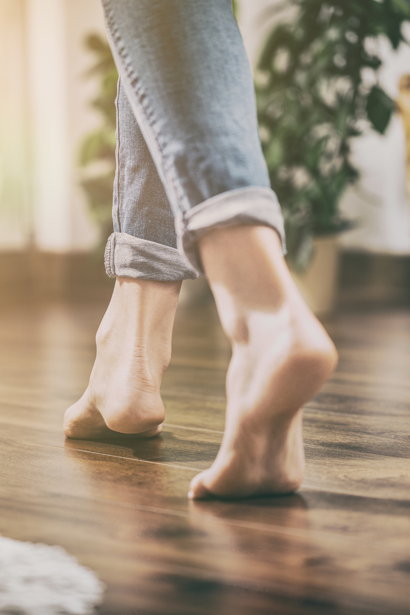 Hiram Flooring Services 10 A woman walking on a wooden floor.