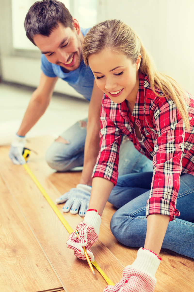 Hiram Flooring Services 9 A man and a woman working on a wooden floor for Hiram Flooring Company.