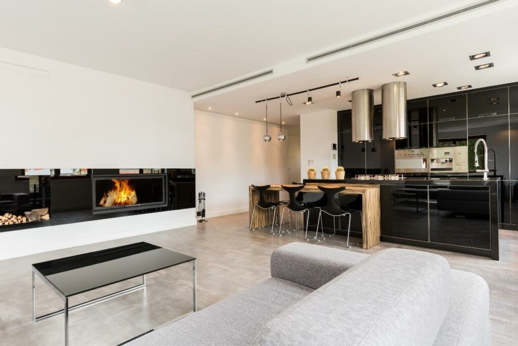 Creating Harmony: Unveiling the Perfect Furniture and Floor Color Combinations 3 Modern kitchen and living room with a fireplace, showcasing furniture and floor color combinations.
