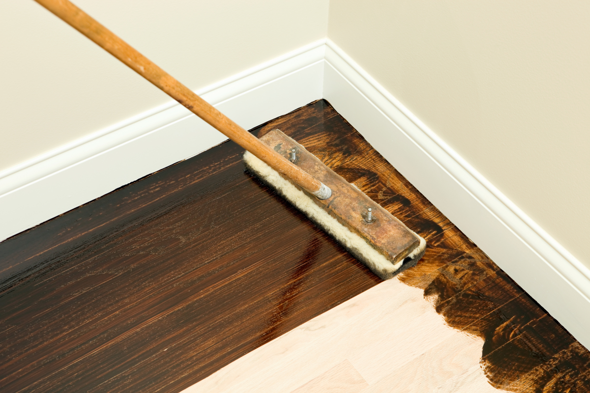 A hardwood floor stain is being applied on the floor.