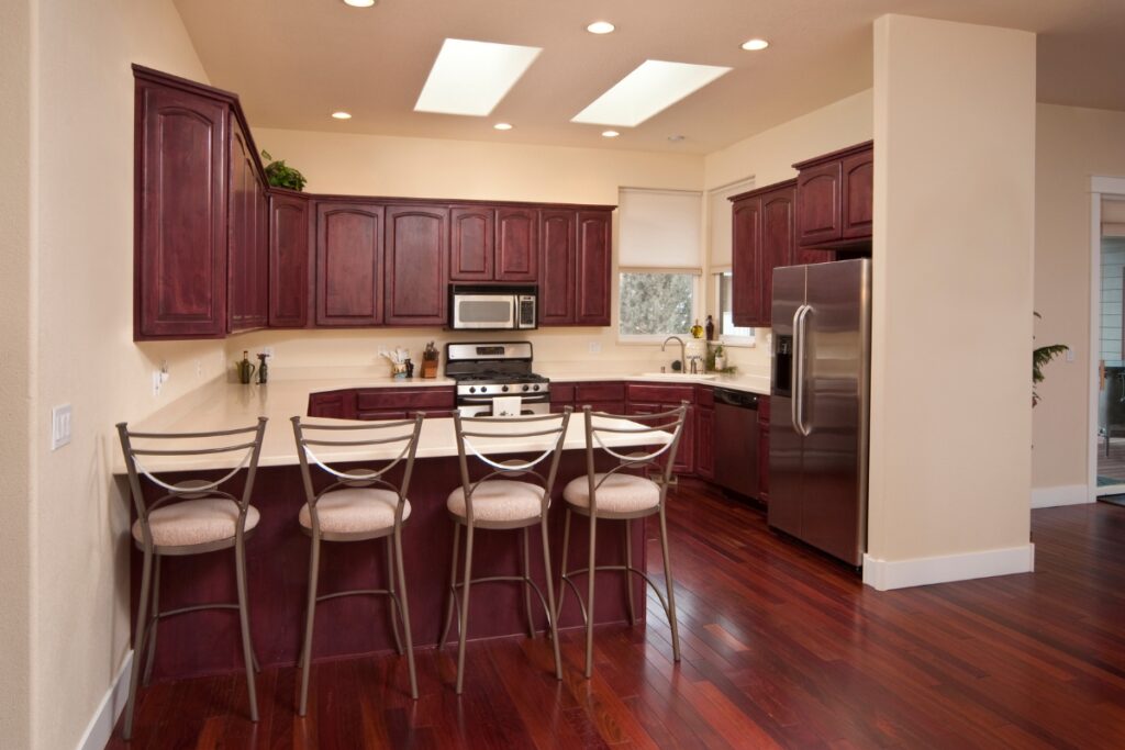 The Pros and Cons of Hardwood Flooring in Kitchens 3 A kitchen with dark wood cabinets and hardwood flooring.