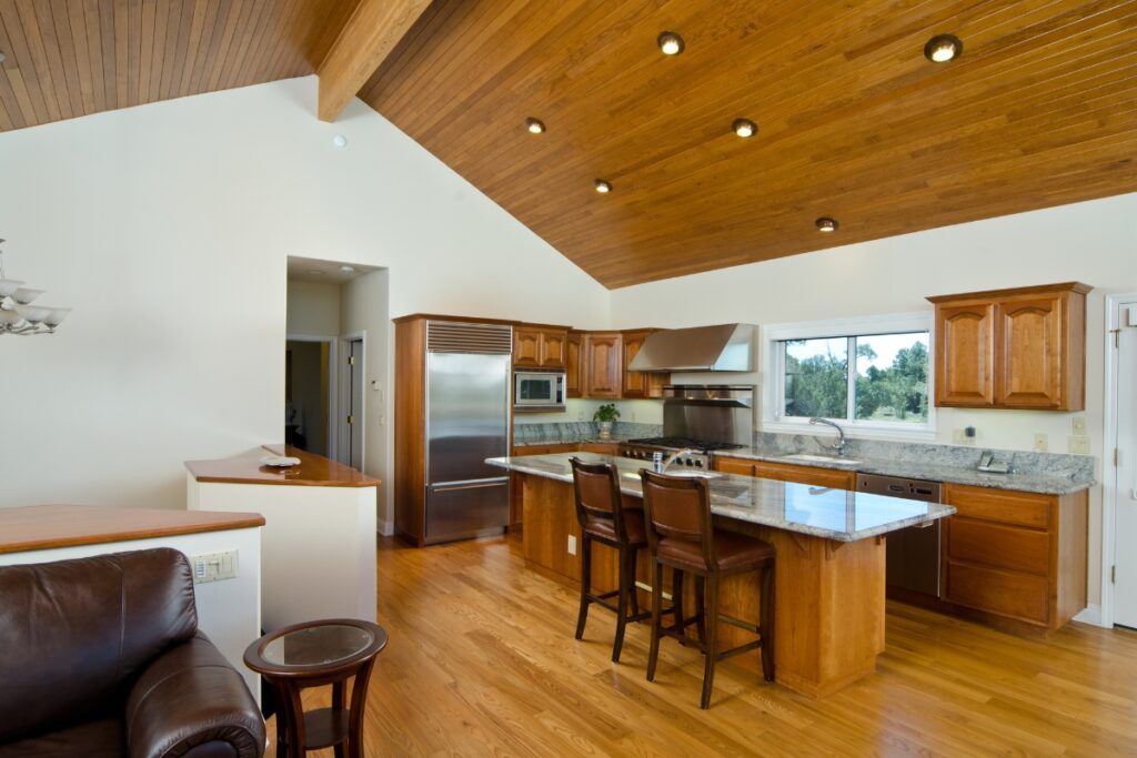 The Pros and Cons of Hardwood Flooring in Kitchens 5 A kitchen with hardwood flooring and wood ceilings.