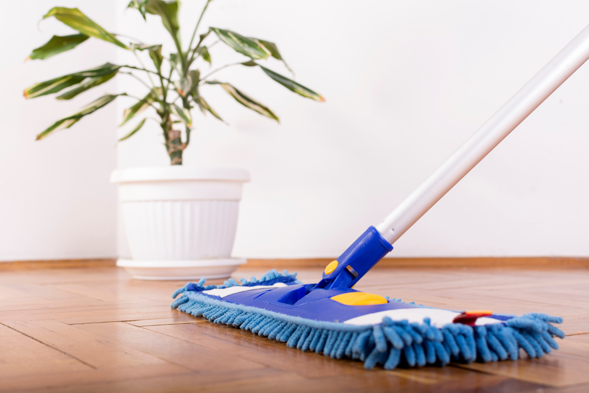 Flooring Maintenance Tips: Using a mop on a wooden floor.