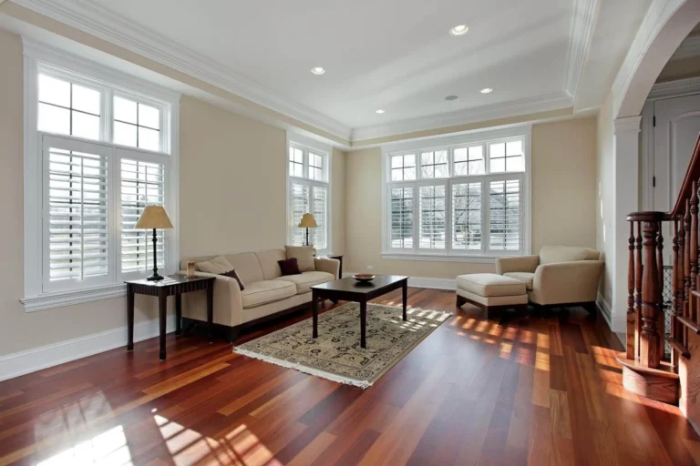 Bright living room with hardwood floors, large windows, and stylish furniture.