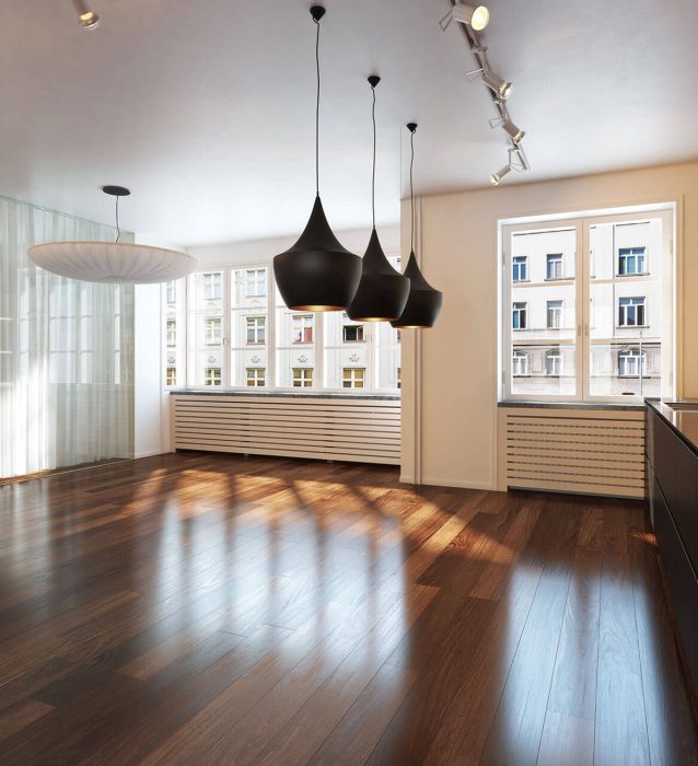 An empty kitchen with hardwood floors.