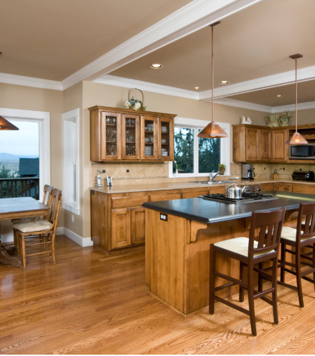 A kitchen with wooden floors furnished with a table and chairs from Austell Flooring Company.