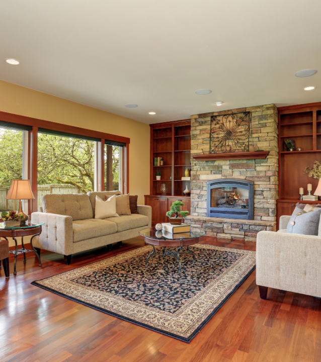 A living room with a fireplace designed by Chamblee Flooring Company. A living room with a fireplace designed by Chamblee Flooring Company.