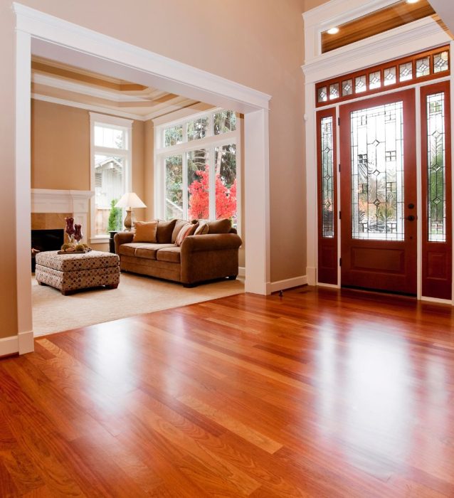 An empty living room with hardwood floors. An empty living room with hardwood floors.
