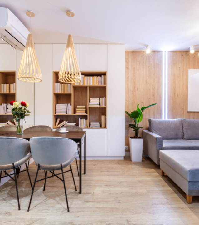 A living room with a dining table and chairs sitting on flooring installed by a Dunwoody Flooring Company.