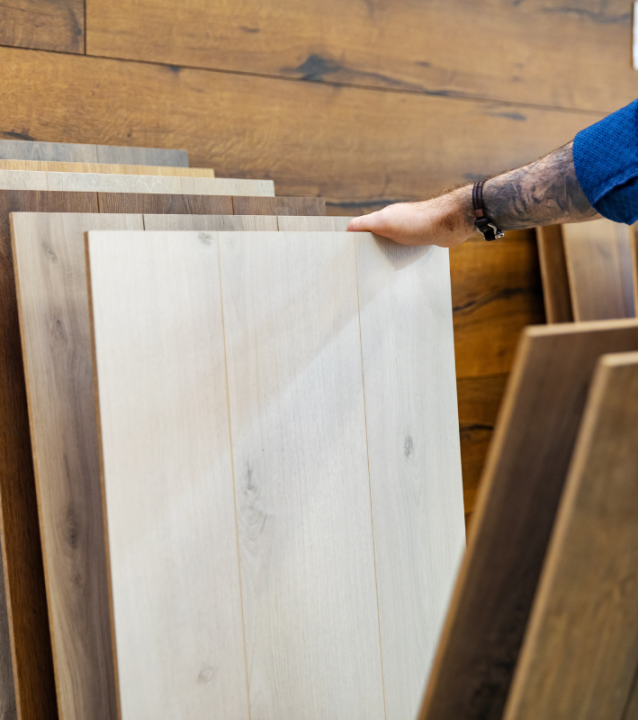 A man is looking at wood flooring samples at Hiram Flooring Company.
